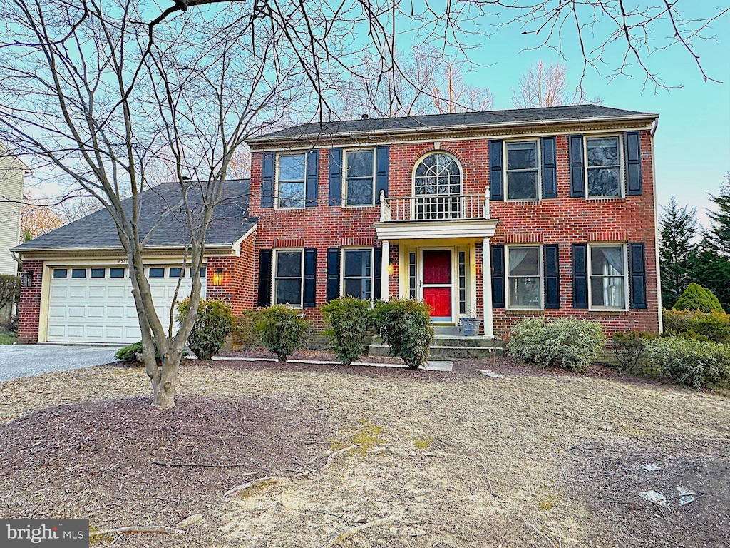 view of front of house with a garage, brick siding, and driveway