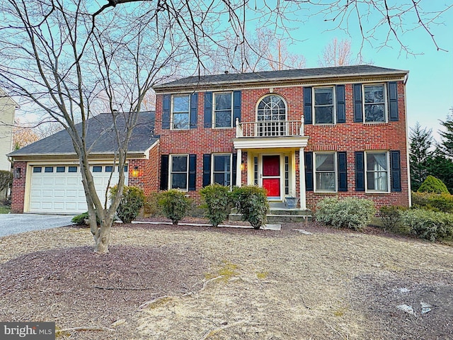 view of front of house with a garage, brick siding, and driveway