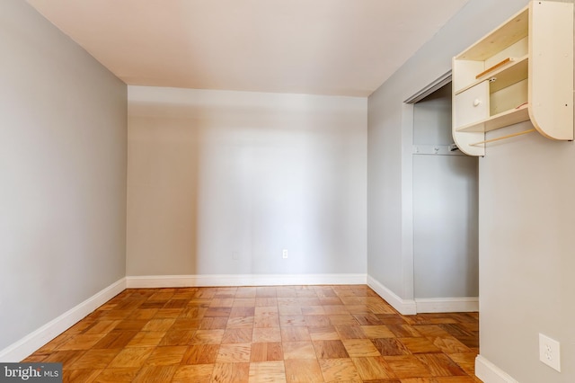 unfurnished room with baseboards