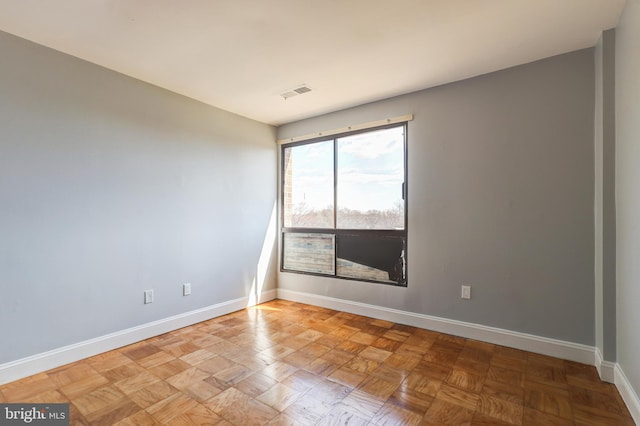 spare room with visible vents and baseboards