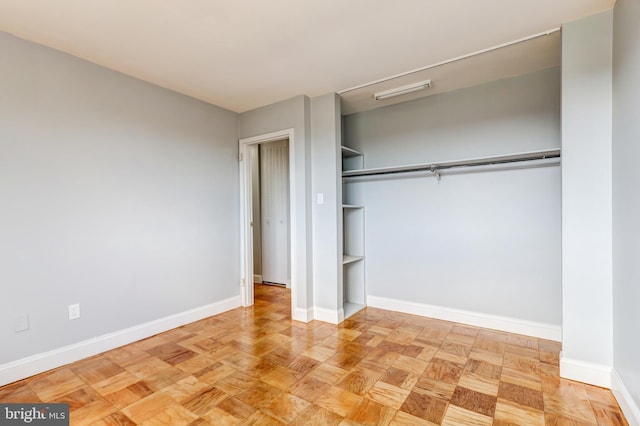 unfurnished bedroom with a closet and baseboards