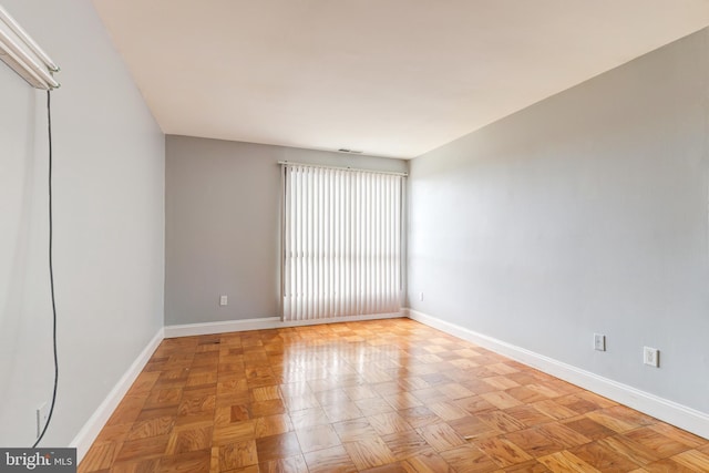 spare room with baseboards