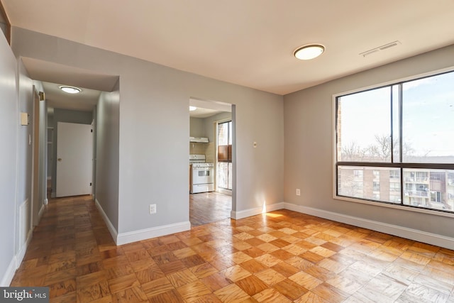 empty room featuring visible vents and baseboards