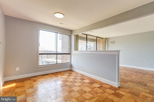 spare room with visible vents and baseboards