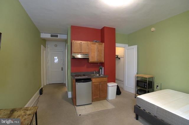 kitchen with visible vents, a sink, under cabinet range hood, light colored carpet, and stainless steel dishwasher