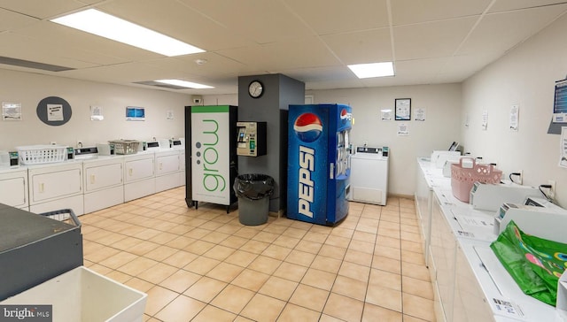 shared laundry area featuring light tile patterned floors and washing machine and dryer