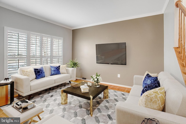 living room featuring wood finished floors, baseboards, and ornamental molding