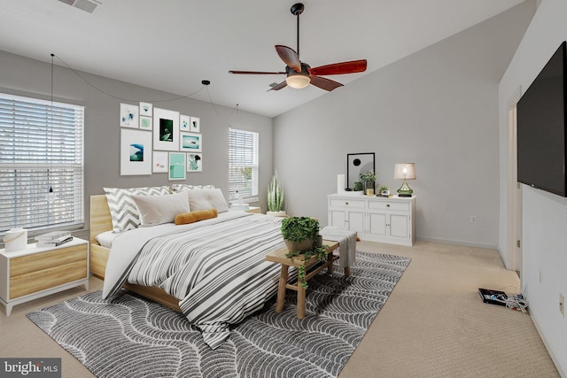 bedroom with lofted ceiling, baseboards, and light carpet