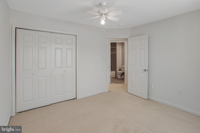 unfurnished bedroom with a closet, carpet flooring, a ceiling fan, and baseboards