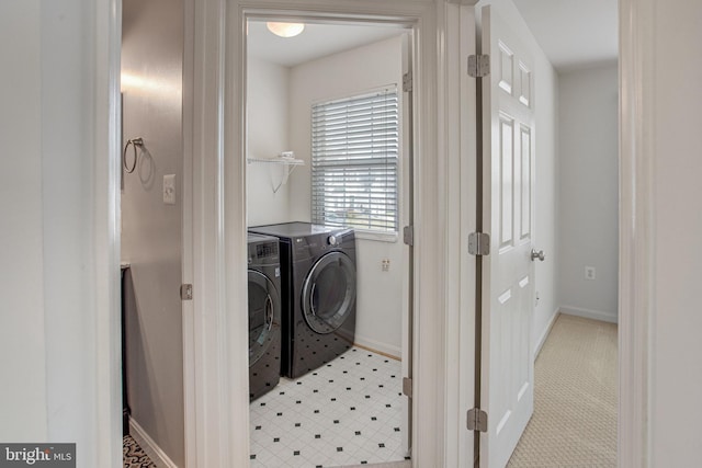 laundry room with baseboards, laundry area, and washing machine and clothes dryer