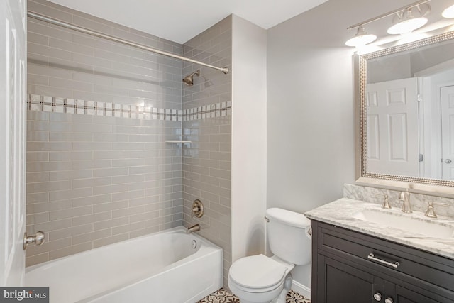 bathroom featuring washtub / shower combination, baseboards, toilet, and vanity