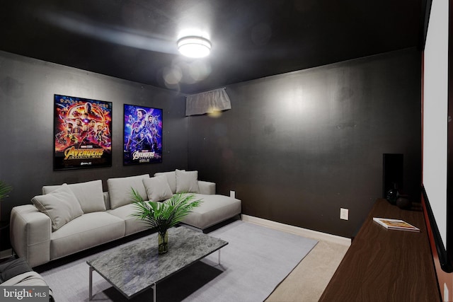 carpeted cinema room with baseboards