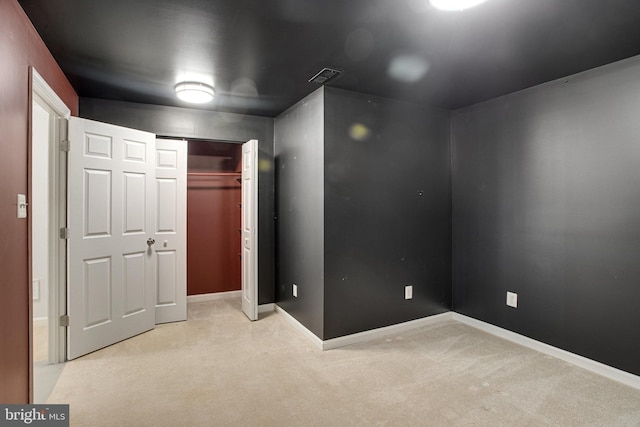 unfurnished bedroom with carpet, visible vents, a closet, and baseboards