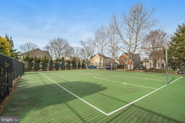 view of basketball court with community basketball court and fence