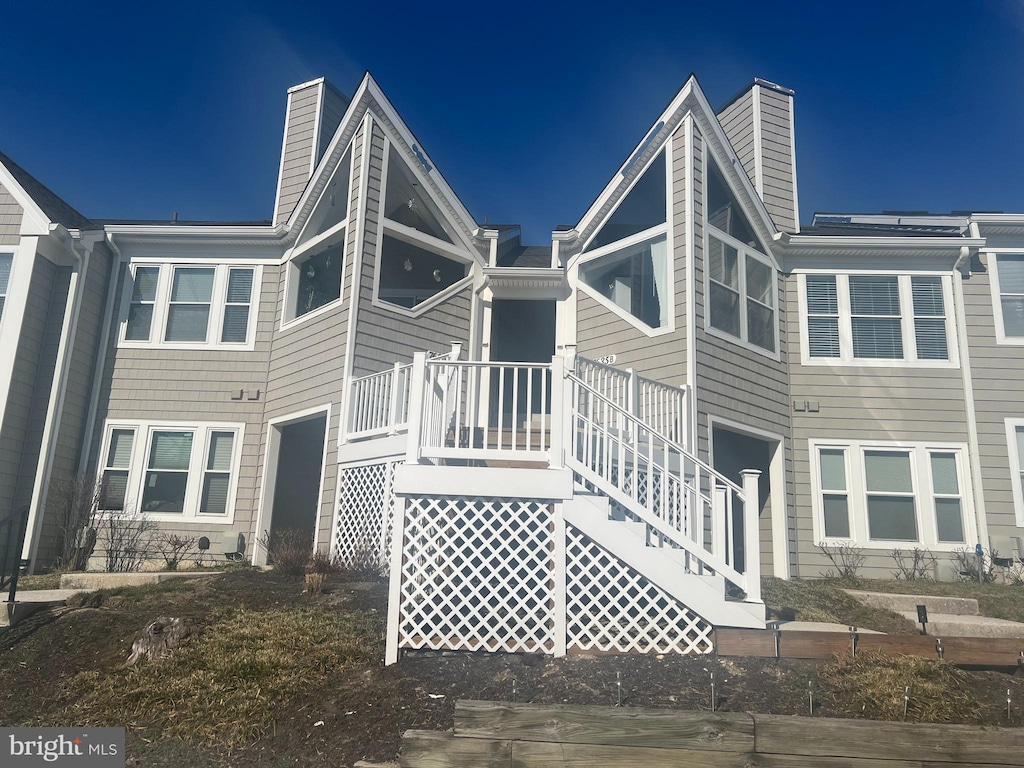 exterior space featuring stairway and a chimney