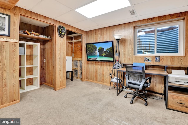 office space featuring visible vents, baseboards, wood walls, carpet flooring, and a paneled ceiling