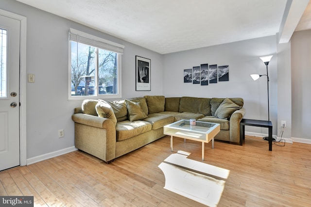 living area featuring light wood-type flooring and baseboards