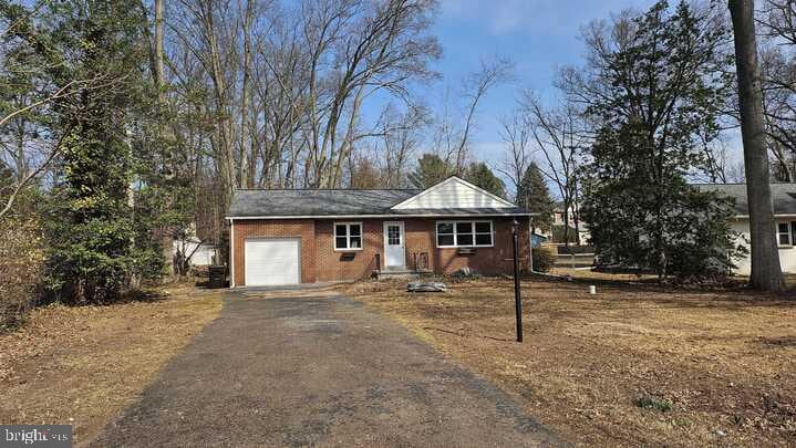 single story home with an attached garage and driveway