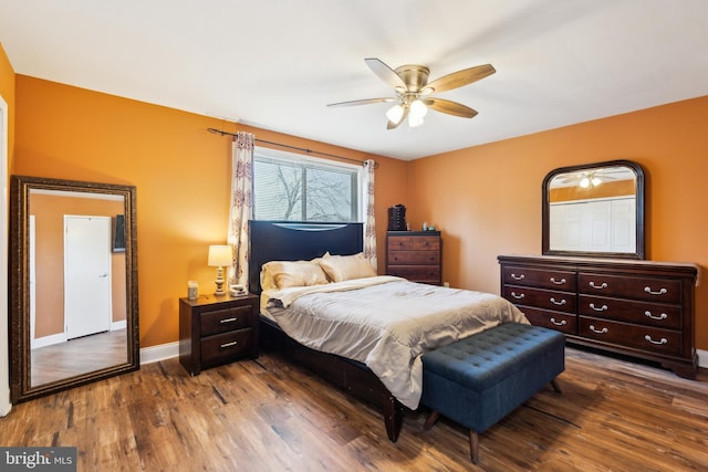 bedroom with ceiling fan, baseboards, and wood finished floors