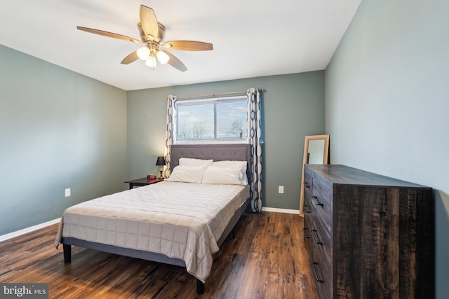 bedroom featuring dark wood-style floors, a ceiling fan, and baseboards