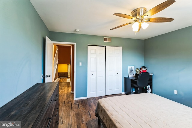 bedroom featuring visible vents, baseboards, a closet, dark wood-style floors, and a ceiling fan