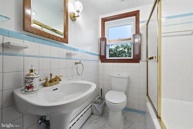 full bathroom featuring a wainscoted wall, bath / shower combo with glass door, a sink, toilet, and marble finish floor