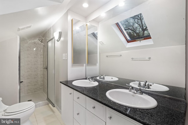 full bath with a sink, visible vents, lofted ceiling with skylight, and toilet