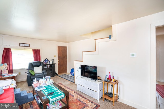 carpeted living room featuring baseboards