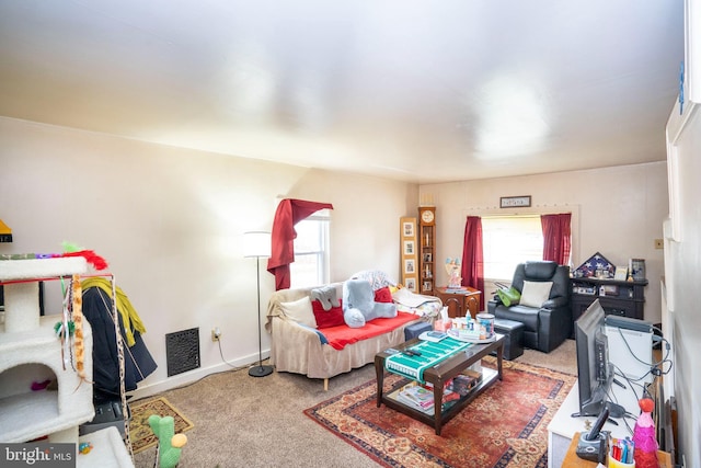 living room featuring baseboards, carpet floors, and visible vents