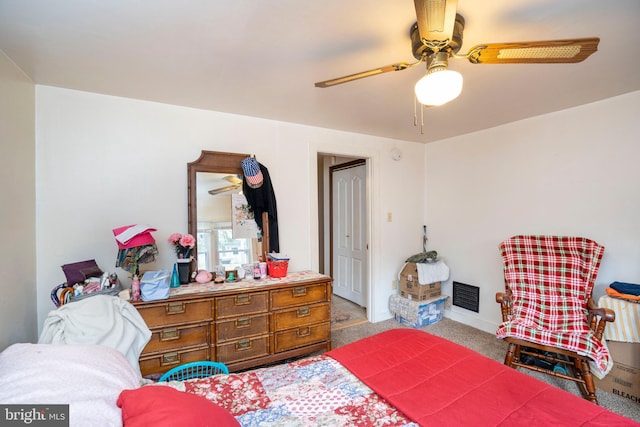 bedroom featuring visible vents, carpet, and a ceiling fan