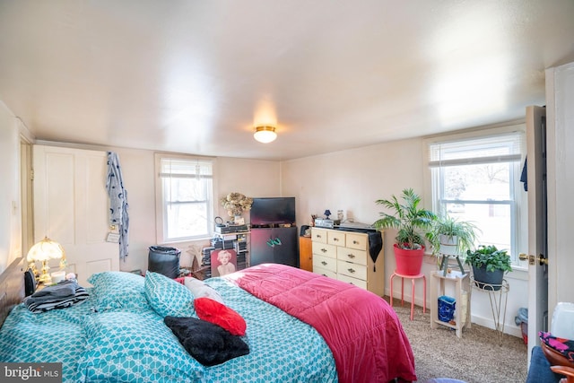 carpeted bedroom featuring baseboards