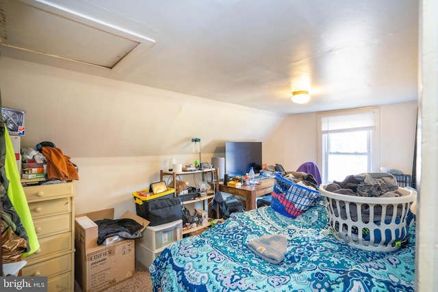 bedroom featuring lofted ceiling and attic access