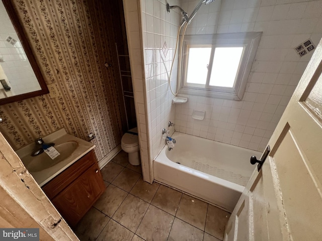 bathroom featuring toilet, bathtub / shower combination, vanity, and tile patterned flooring