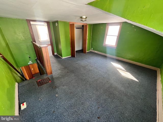 additional living space with carpet and baseboards