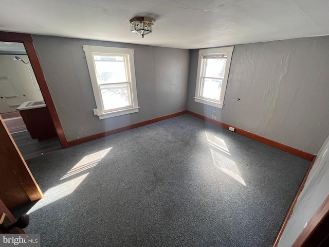 interior space featuring carpet and baseboards