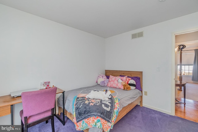 carpeted bedroom featuring visible vents and baseboards