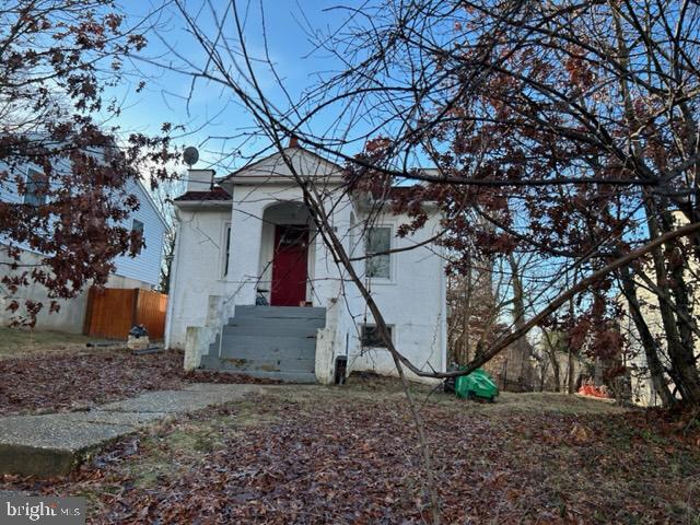 view of property exterior featuring a chimney and fence