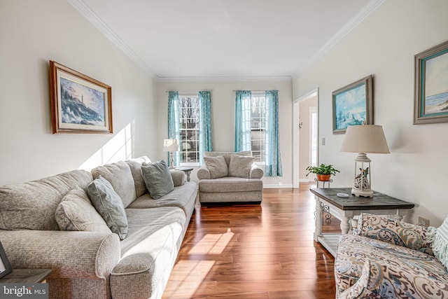 living room with baseboards, hardwood / wood-style floors, and crown molding