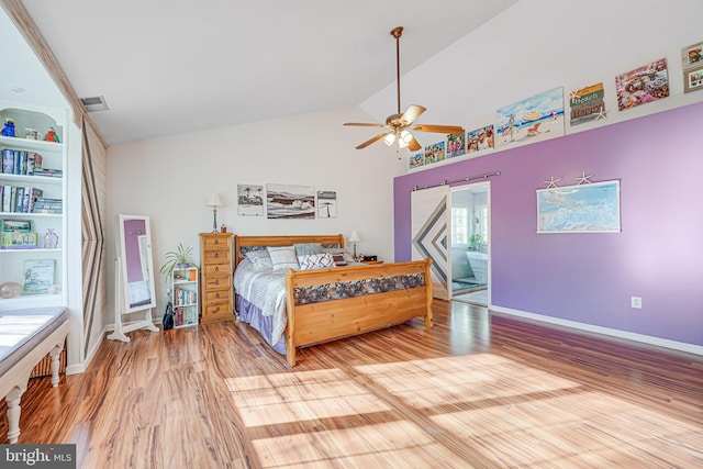 bedroom featuring a ceiling fan, visible vents, baseboards, vaulted ceiling, and light wood-type flooring