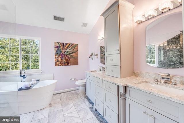 full bathroom featuring a soaking tub, double vanity, visible vents, and a sink