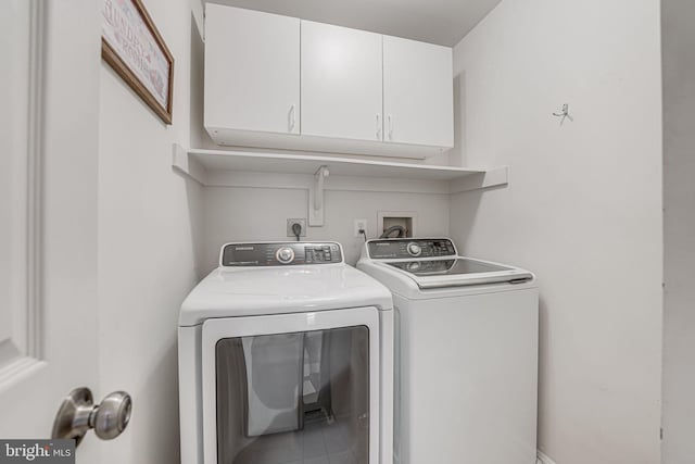 laundry room featuring cabinet space and separate washer and dryer