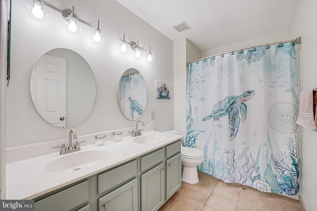 bathroom with tile patterned flooring, visible vents, double vanity, and a sink