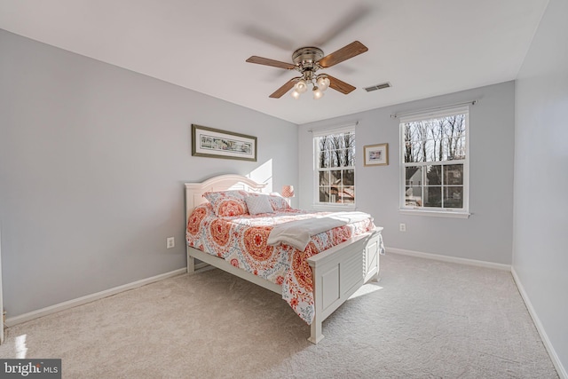 bedroom featuring carpet flooring, baseboards, visible vents, and ceiling fan