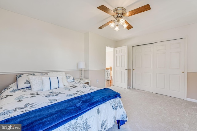 carpeted bedroom with baseboards, a closet, and ceiling fan