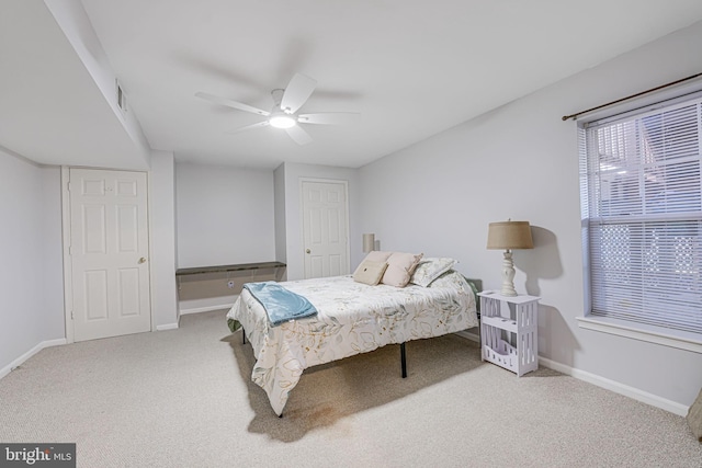 bedroom with visible vents, baseboards, carpet, and a ceiling fan