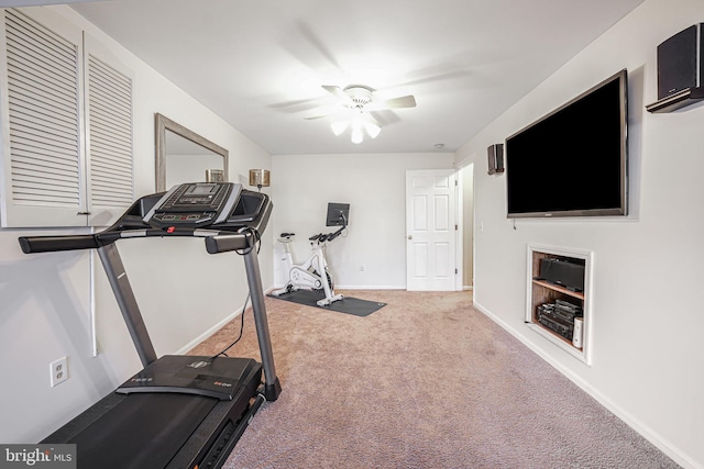 exercise room with carpet, baseboards, and ceiling fan