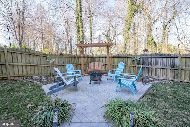 view of patio featuring a fenced backyard and an outdoor fire pit