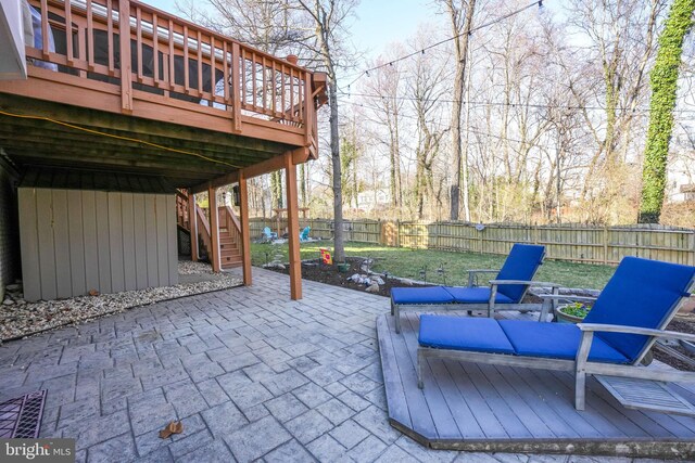 view of patio featuring stairway, a wooden deck, and a fenced backyard