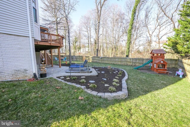 view of yard featuring a patio, a fenced backyard, stairs, a deck, and a playground