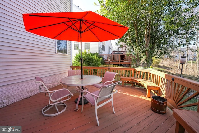 deck featuring outdoor dining area